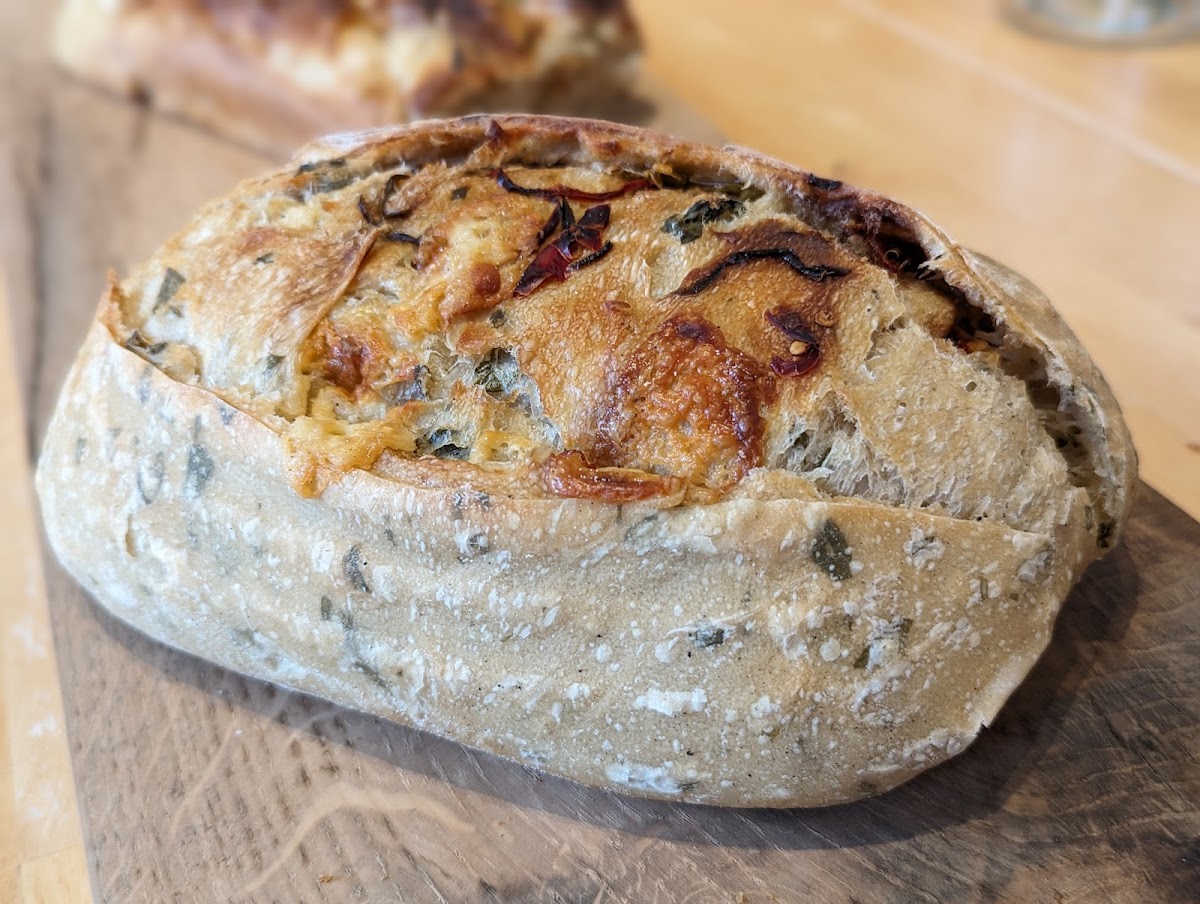 Fresh baked goods and deli rolls on display at The Fat Batard Bakery counter